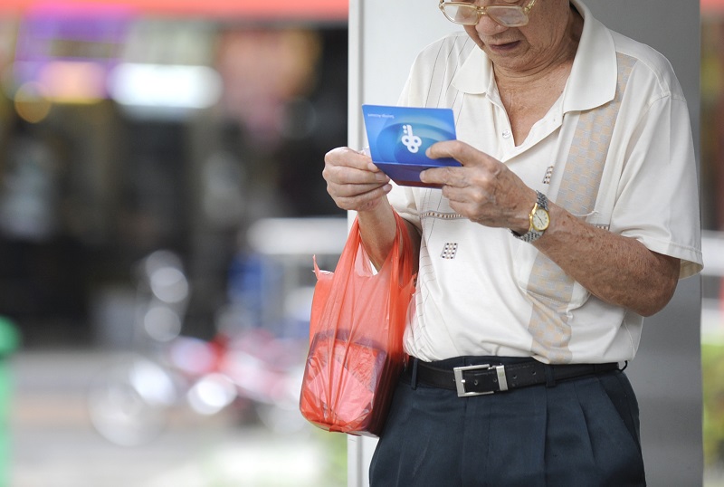 old man checking his savings.jpg