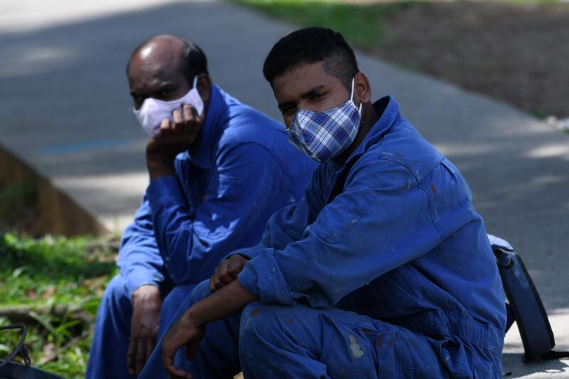 20200416-Foreign workers waiting for trasnport AFP.jpg