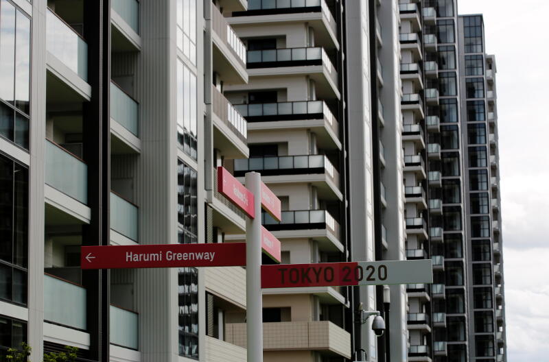 20210622 - Residential buildings are seen behind road signs (Reuters).jpg